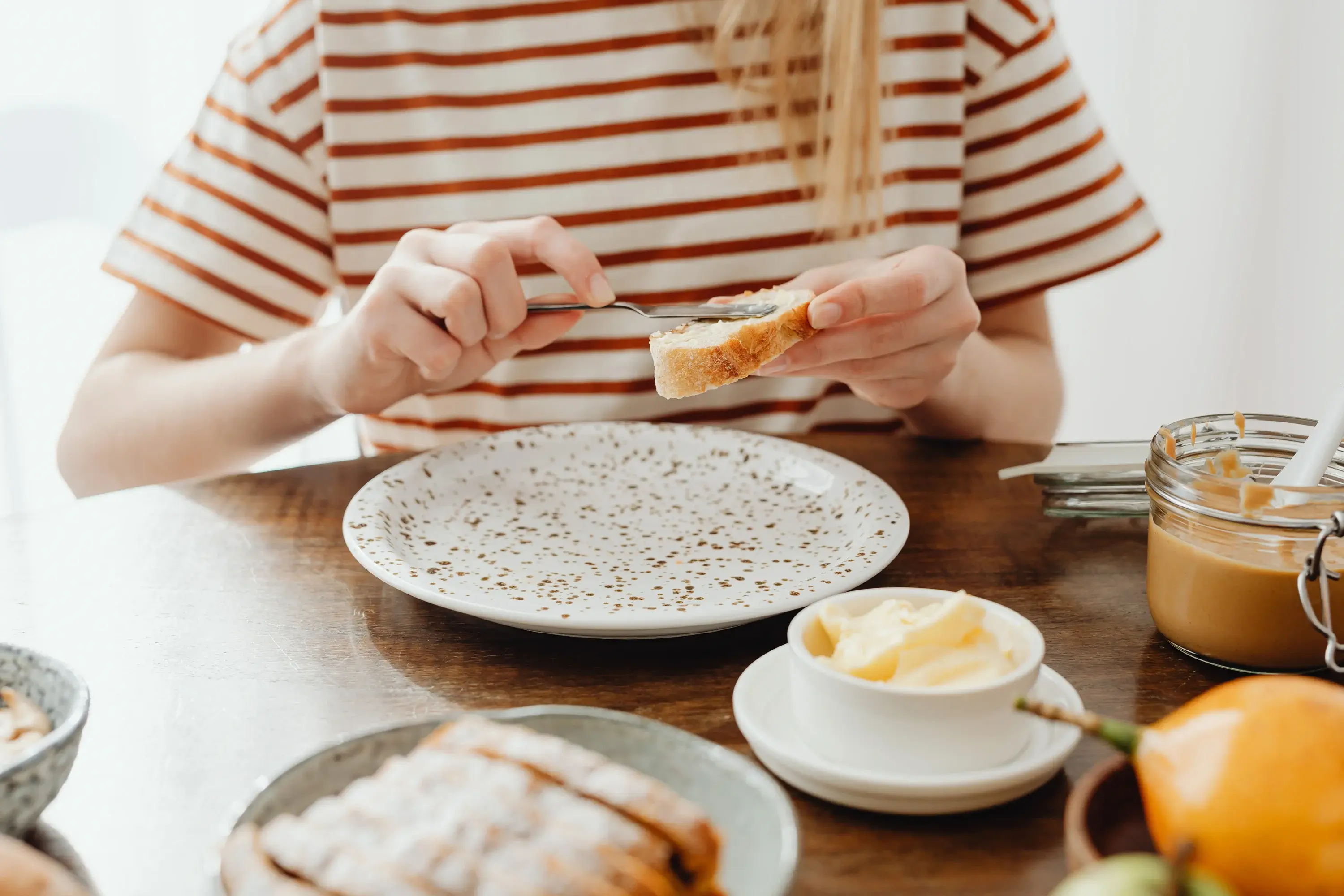 woman spreading butter on bread